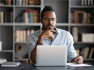 A man researching a product that he plans on purchasing.