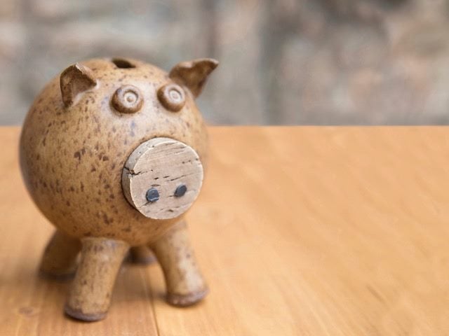 old ceramic piggy bank on a table