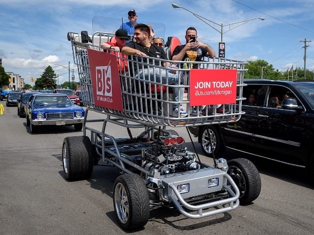 people inside a motorized BJ's shopping cart.