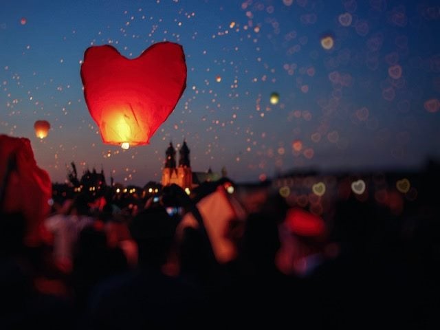 heart-shaped paper  lantern  about to launch into the sky