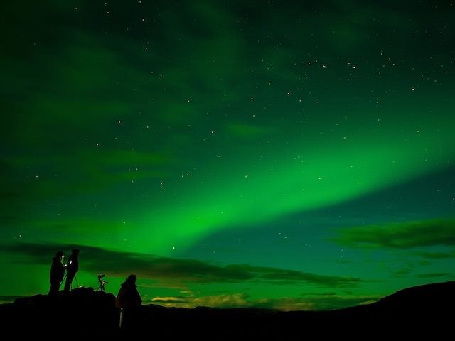 friends hanging out in Iceland photographing the aurora borealis