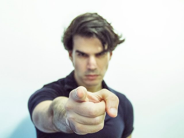 man pointing directly at the (off screen) camera