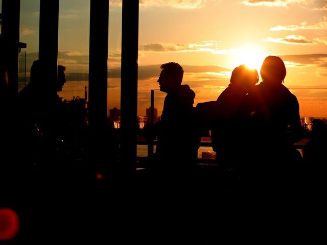People talking at sunset