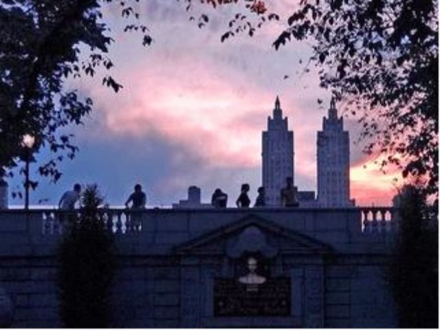 image of people on a bridge at sunset