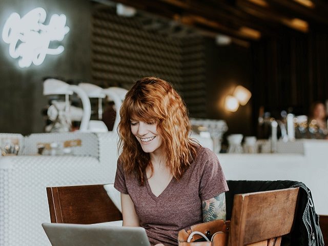 Happy woman using a laptop computer. 