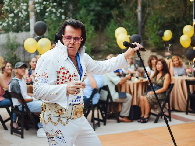 Elvis impersonator entertaining a party