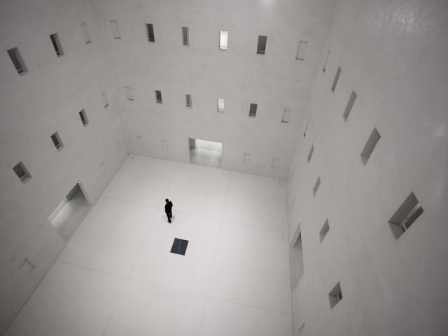 A large white room with many entryways and doors, lots of choices - marketing investment concept