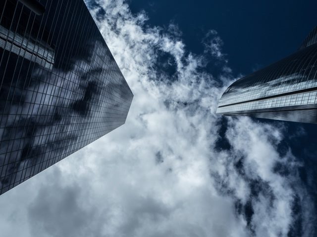 high rise buildings in a cloudy sky
