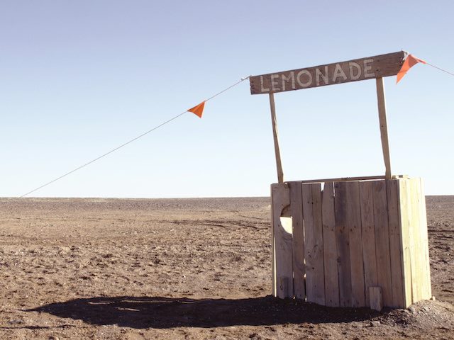 unattended lemonade stand on a beach