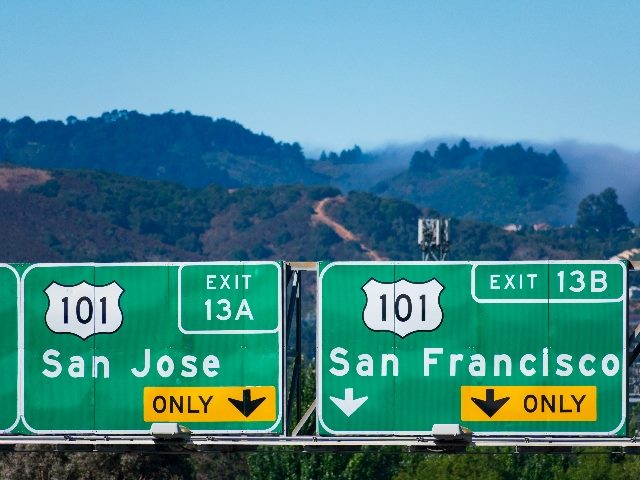 Two side-by-side highway signs that say "San Jose" and "San Francisco" Interstate 101 highway road sign showing drivers the directions to San Jose and San Francisco in Silicon Valley. 