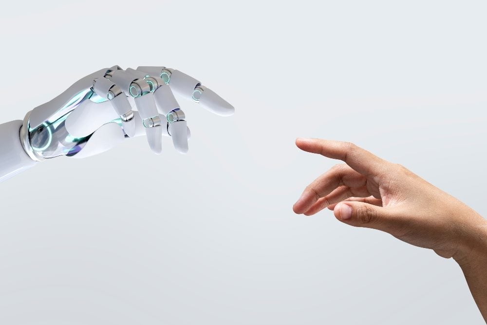 A robot hand and human hand reach out toward each other in piece about maintaining the human touch with AI in SEO.