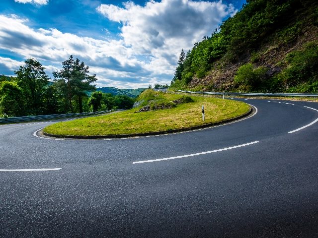 Curve in road amid mountains.