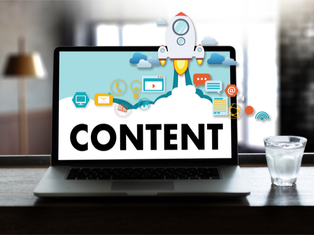 Content marketing concept. A rocket balsting off the screen of a PC monitor