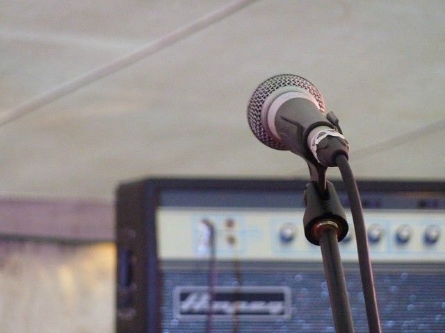 Microphone with a sound system as the backdrop.