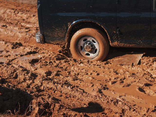 truck with a tire stuck in the mud