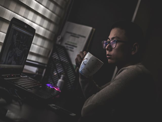 woman contemplating computer