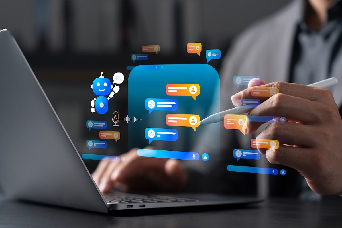 Conceptual illustration of a person using an AI chatbot, shown as floating holographic chat bubbles and a smiling robot above a laptop keyboard.