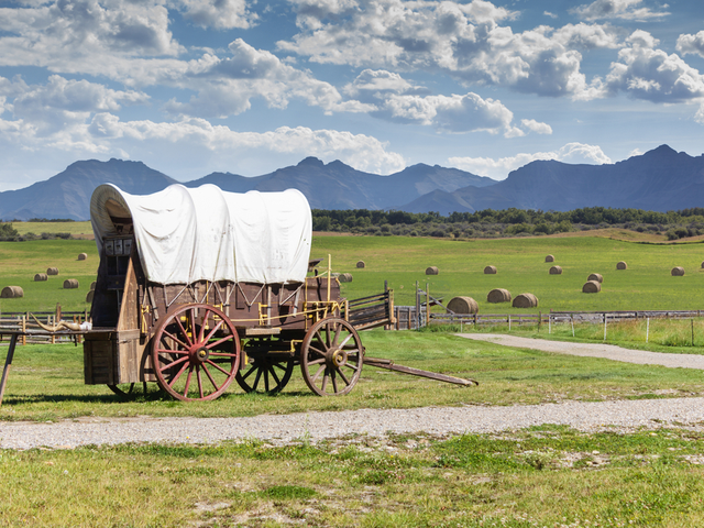 An old-fashioned wagon in a prairie background setting