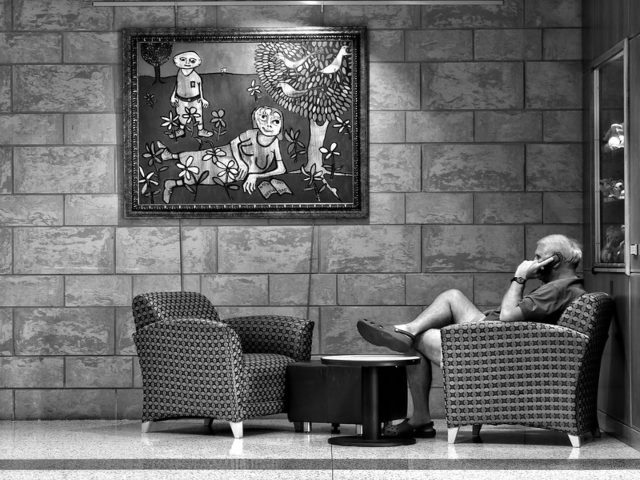 Man sitting down talking on the phone.