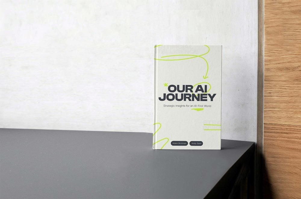 A picture of the the book "Our AI Journey" by Adam Brotman and Andy Sack with black lettering and green swirl designs.