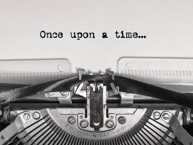 close up of typewriter with "once upon a time" written on the page