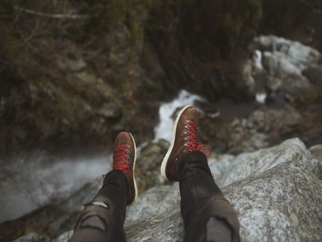 Person sitting on the edge of a cliff - edge computing concept
