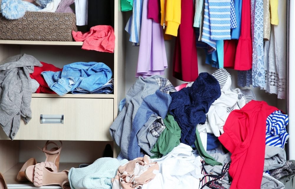 A wardrobe with messy clothes strewn about in piece about martech stack resolutions.