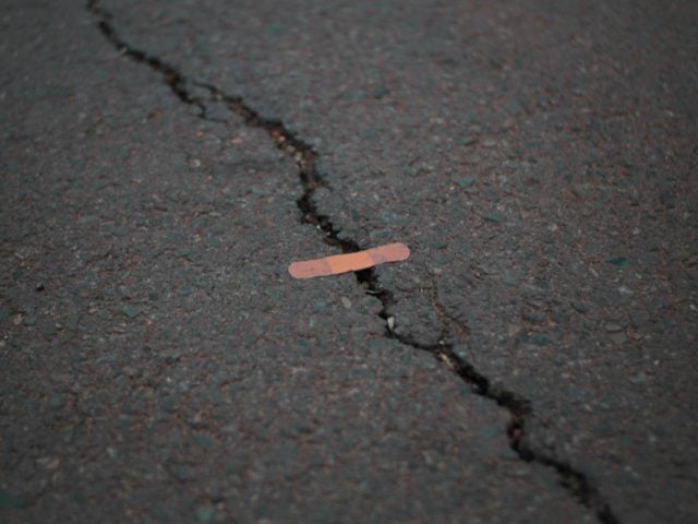 orange bandage on cracked gray concrete surface
