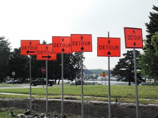 detour signs pointing in many directions