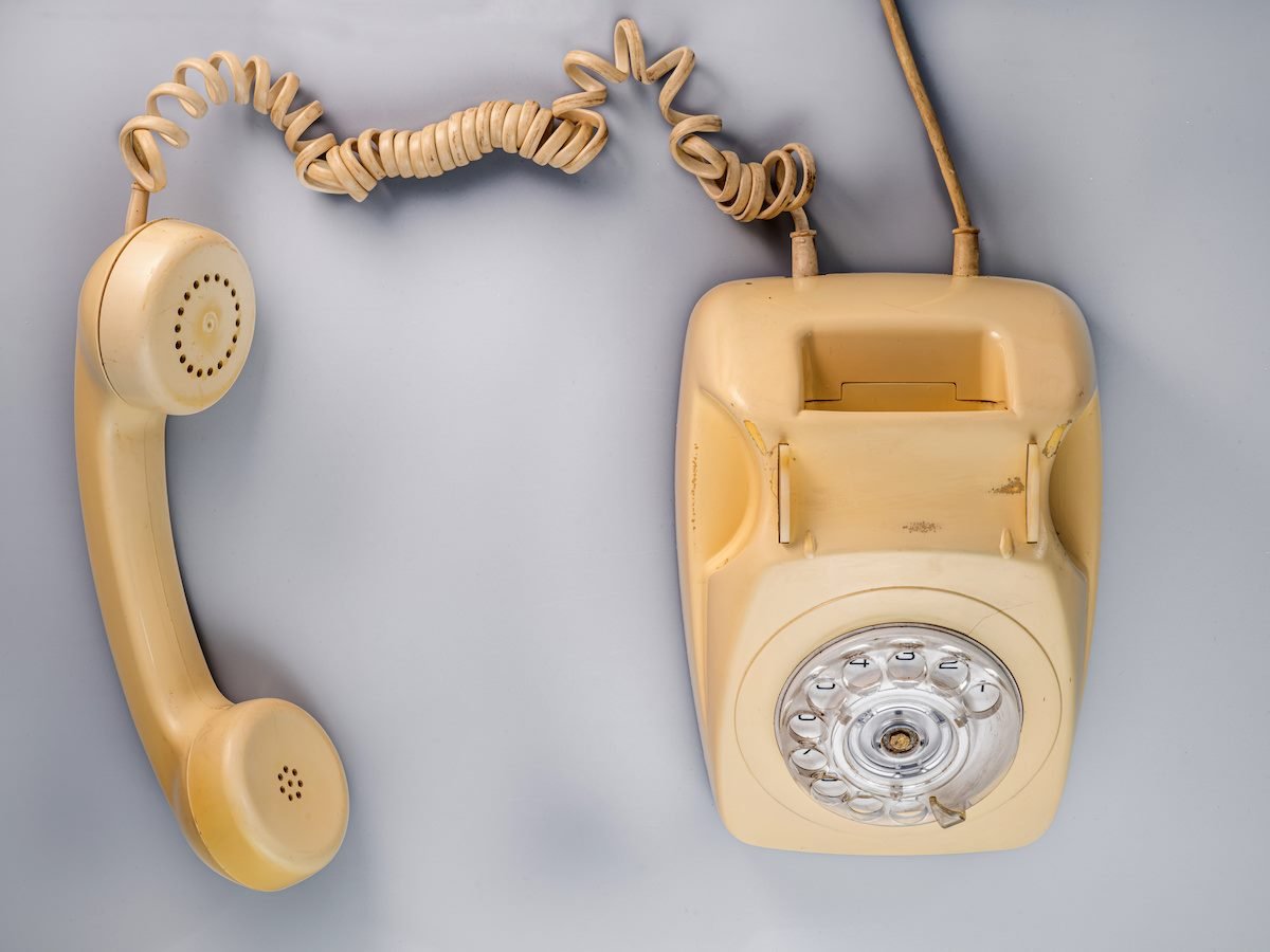 A yellow rotary phone