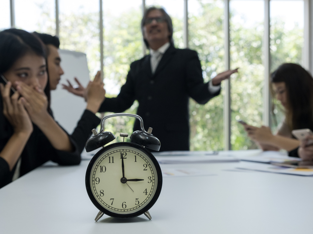 Disengaged workers listening to their boss drone on - employee engagement concept