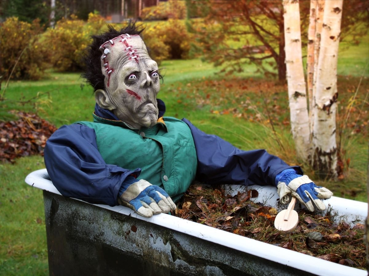 Frankenstein monster costume sitting in a bathtub.