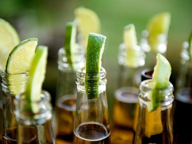 Bottles of Corona beer with limes in the neck opening representing the futures of multisensory customer experience.
