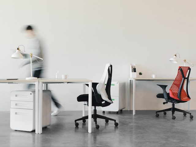 blurred person rushing through  an  empty open plan office