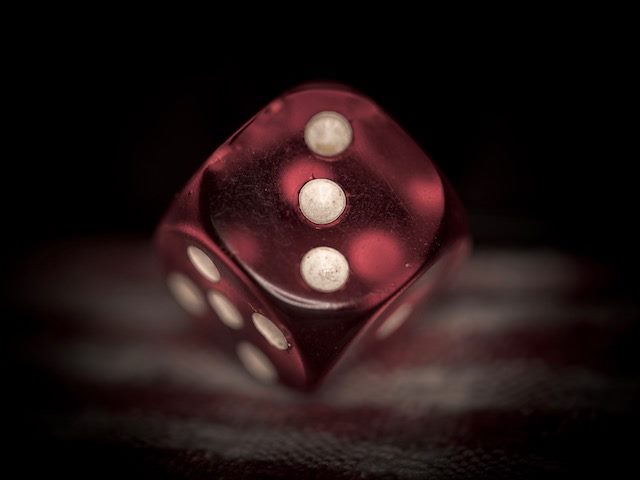 red die with the side with three dots showing