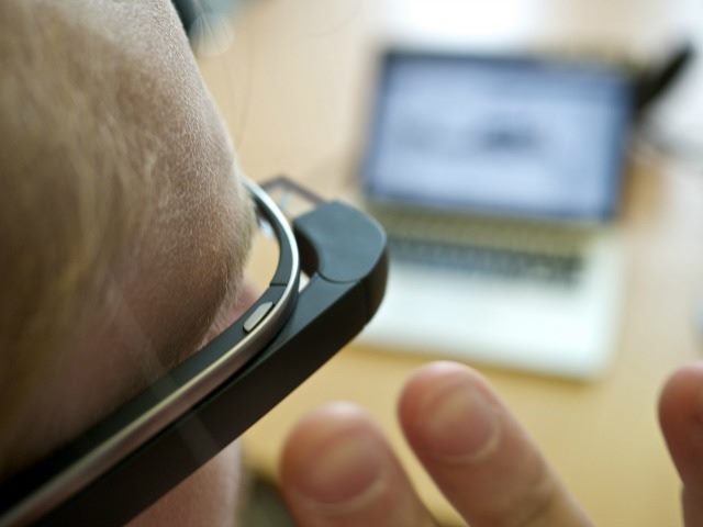 person wearing Google Glass while sitting at their desk