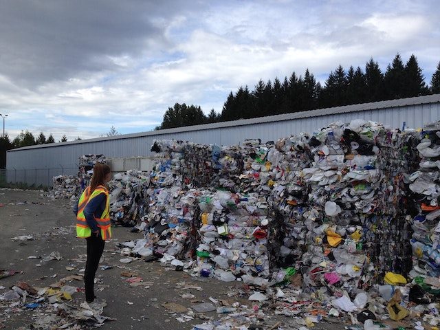 woman surveying compacted trash