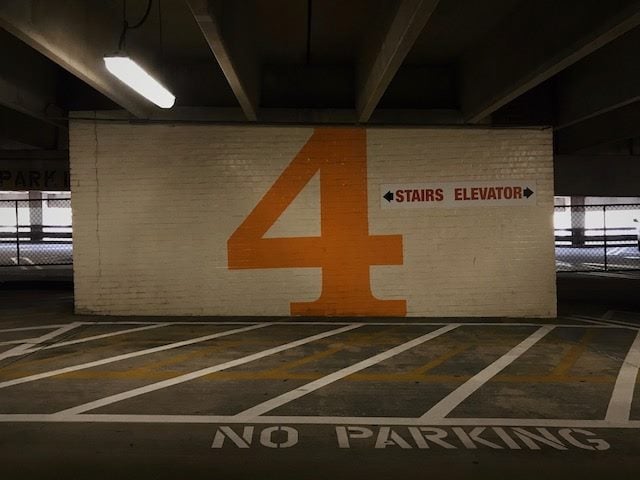 fourth level of a parking  garage, sign for stairs or elevator