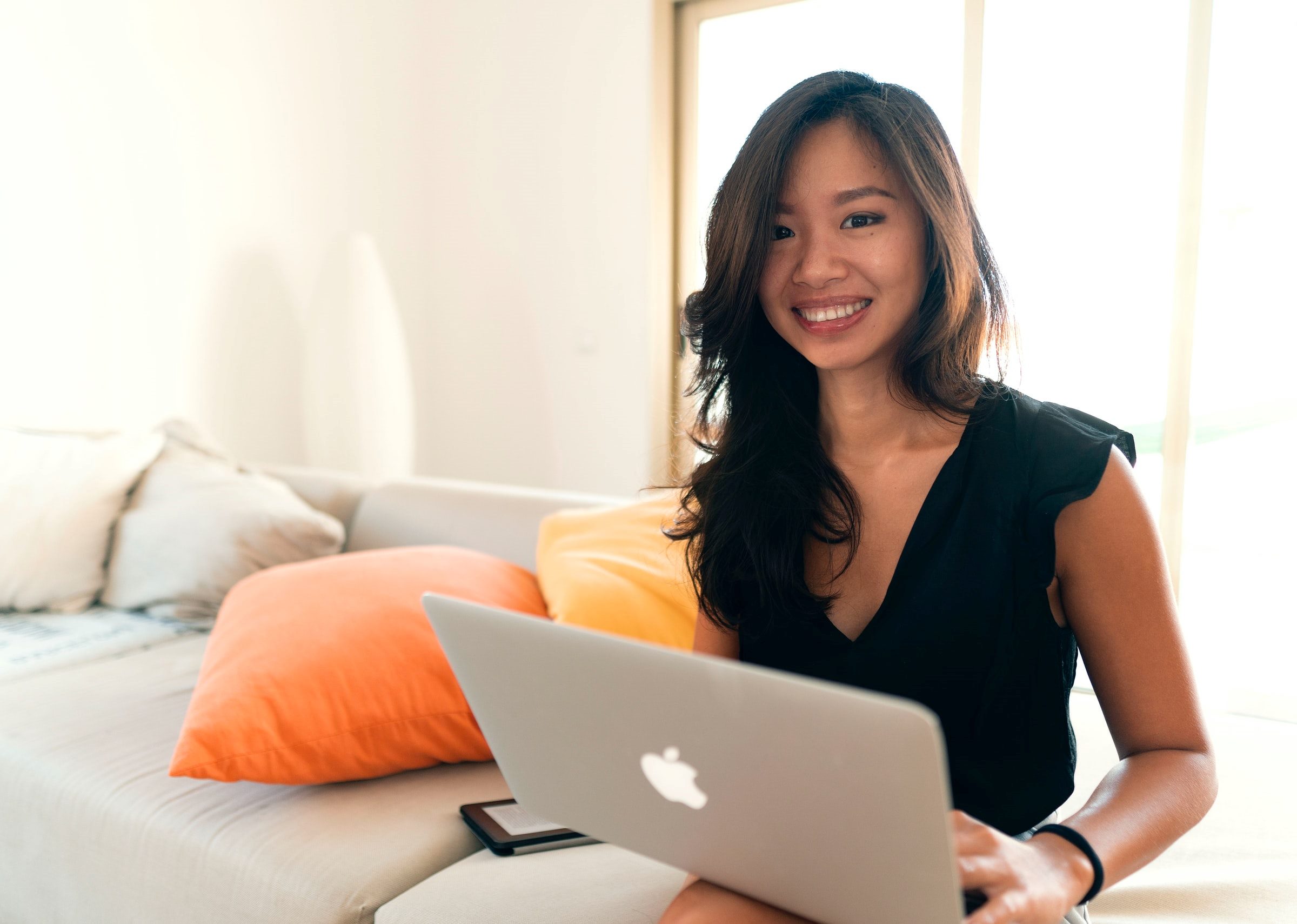 woman smiling with computer