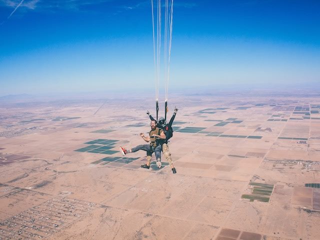 skydiving with a partner over dry land