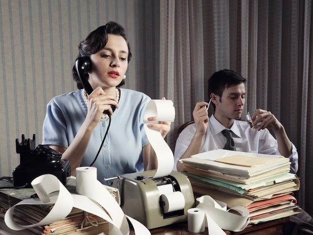'50s scenario, woman calculating and on phone, man in background smoking a pipe