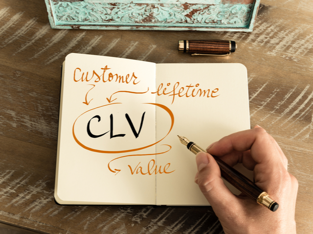 Retro effect and toned image of notebook next to a fountain pen. CUSTOMER LIFETIME VALUE (CLV) Concept 