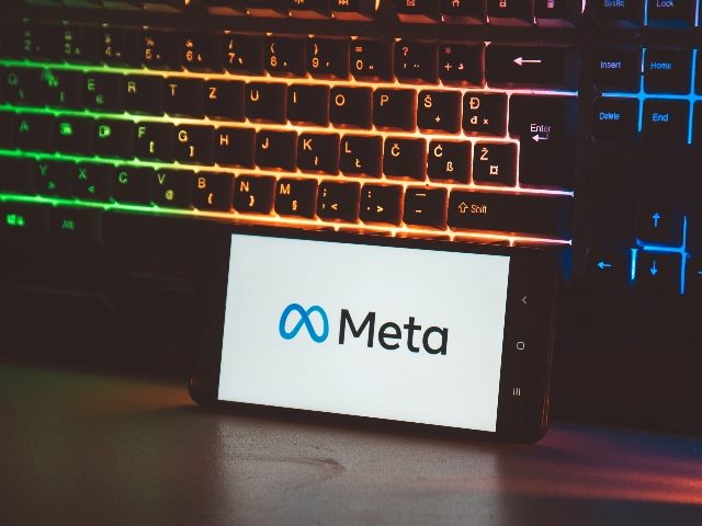 Meta logo, Facebook rebranding to new name and logo Meta, shown on mobile phone.