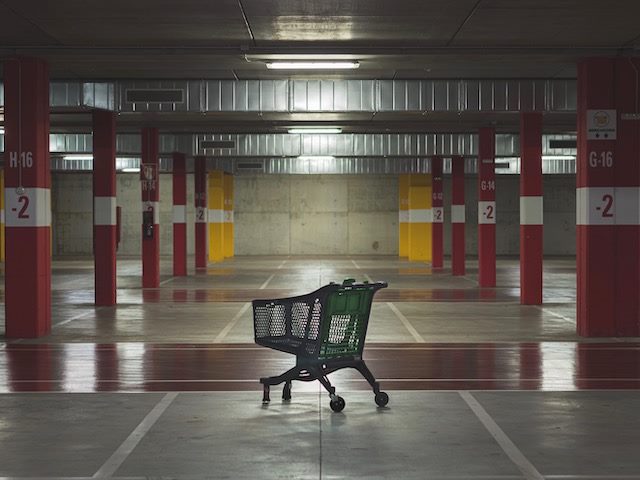 abandoned shopping cart in an empty parking garage