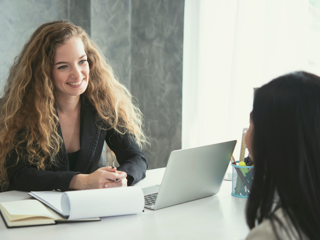 A customer support rep talking in-person with a customer 