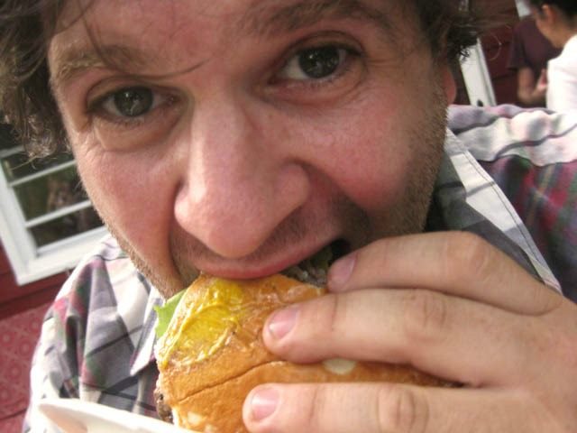 taking a big bite out of a burger