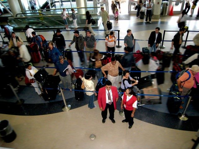 People waiting in line at an airport.