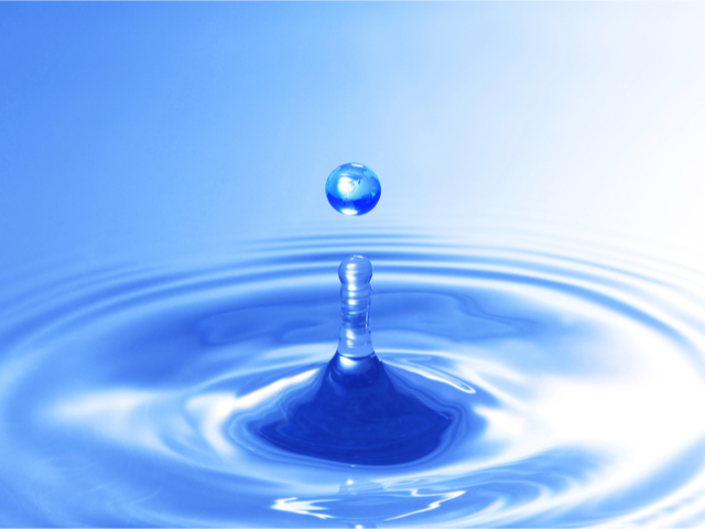 A water droplet splashing into blue water - Drip Marketing campaign concept