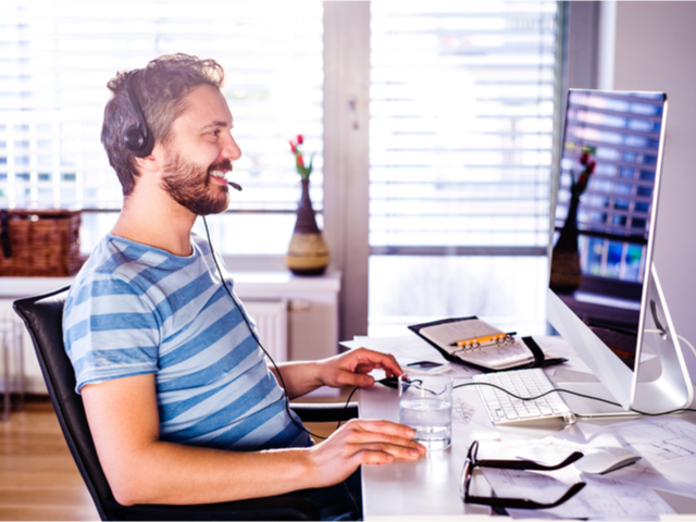 Man sitting at desk working from home on his computer