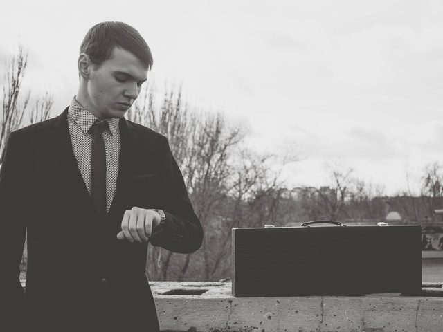 young man looking at his watch